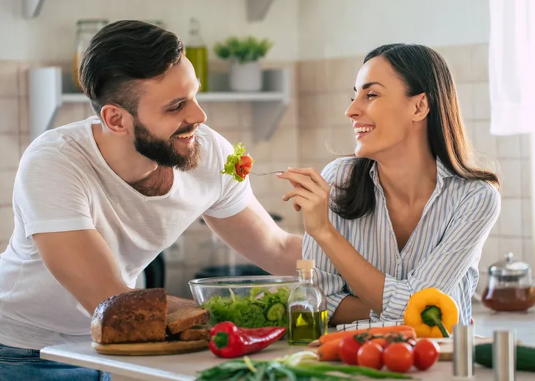 Couple preparing and sharing a nutritious meal